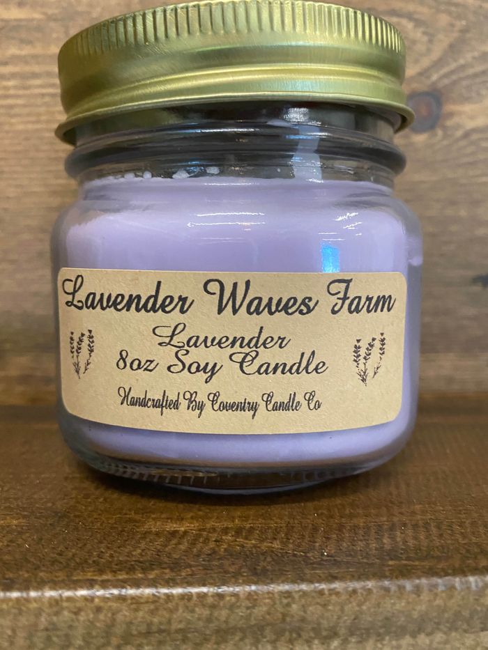 A Lavender Waves Farm lavender soy candle in a glass jar with a gold lid