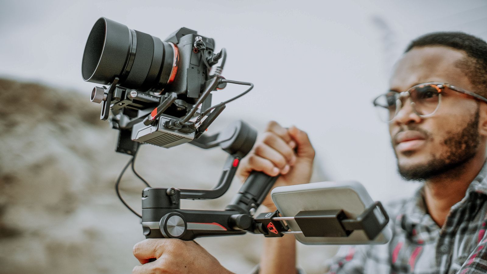 A videographer filming — camels on camera
