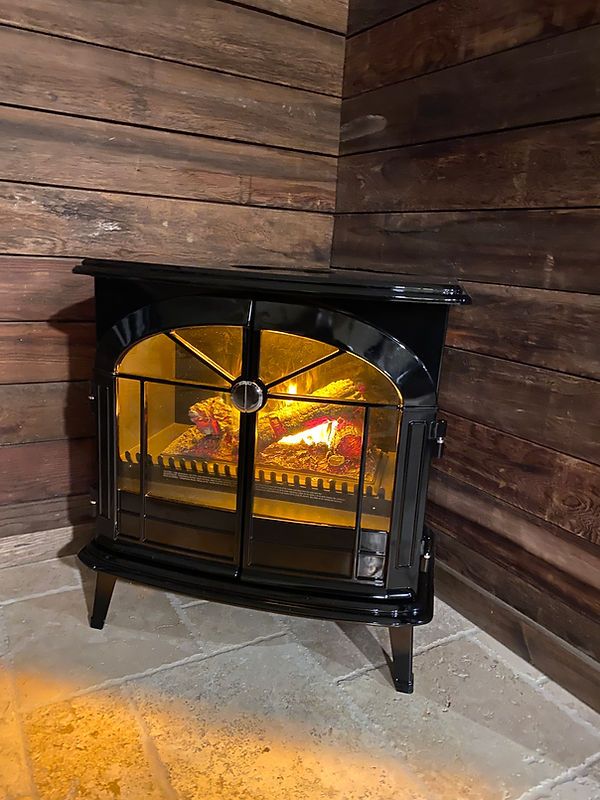 The suite's wood-trimmed stove, glowing warm