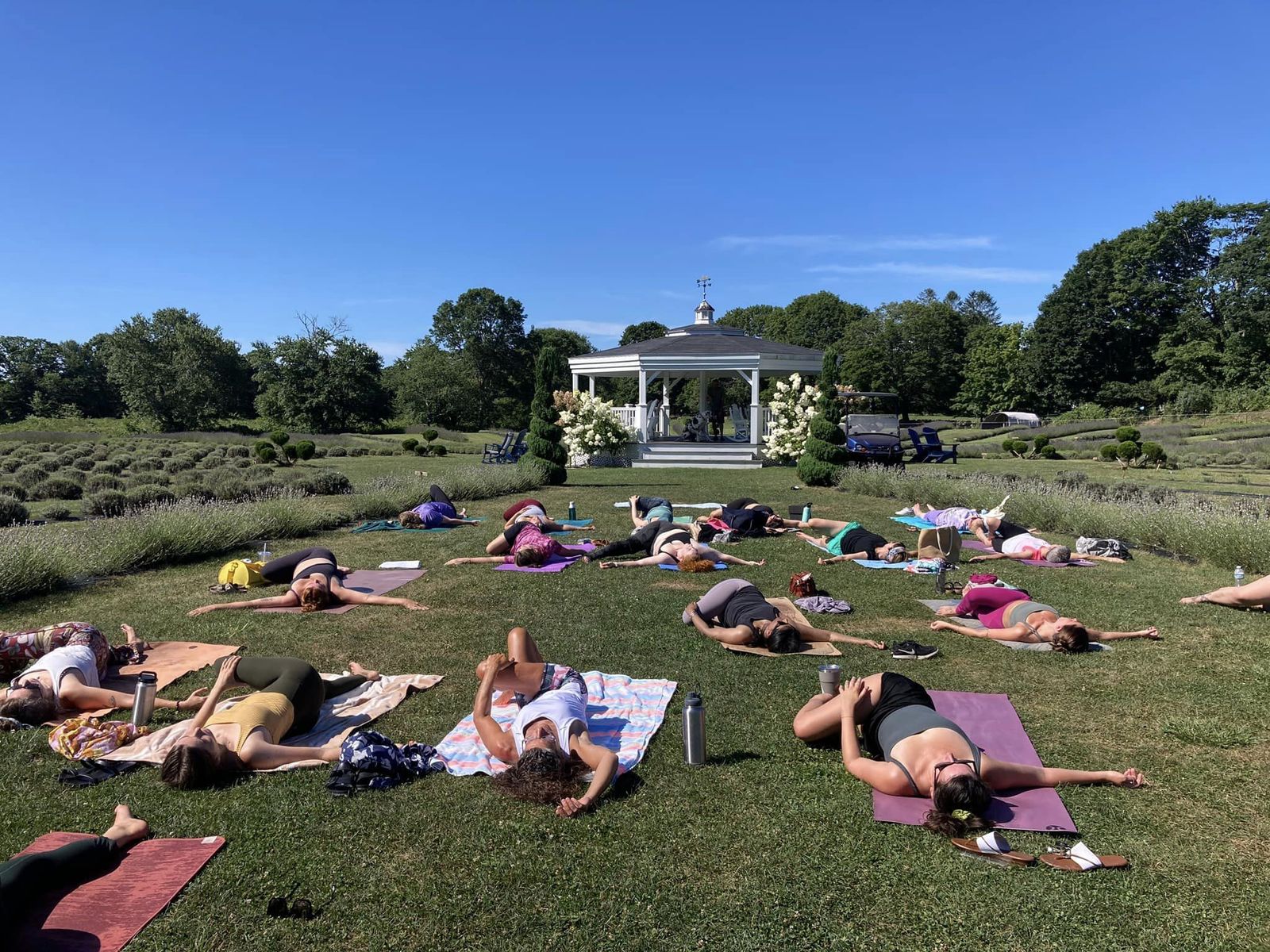 Yoga in the field with the gazebo behind